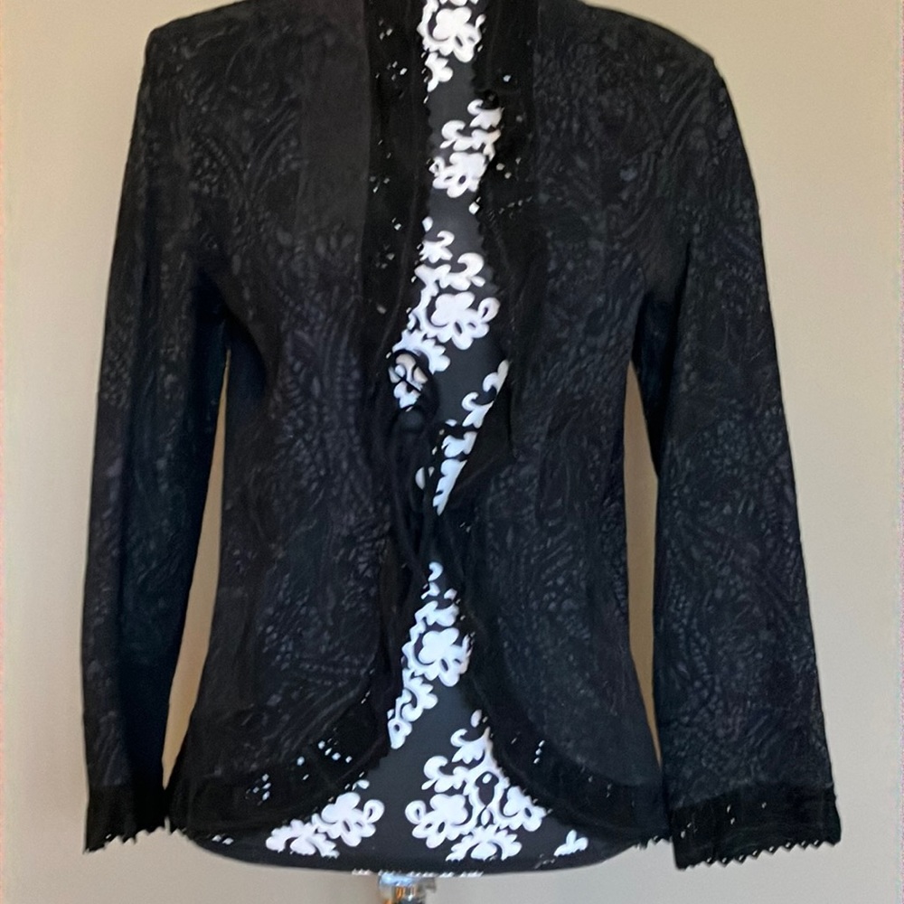 Fabulous laser cut black jacket w/ ruffle around collar front sleeves & bottom.